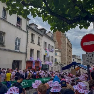 Spectators filling the narrow cobblestone street of Rue Lepic in Montmartre Paris, awaiting the cyclists fighting for the final stage win of Tour de France 2025